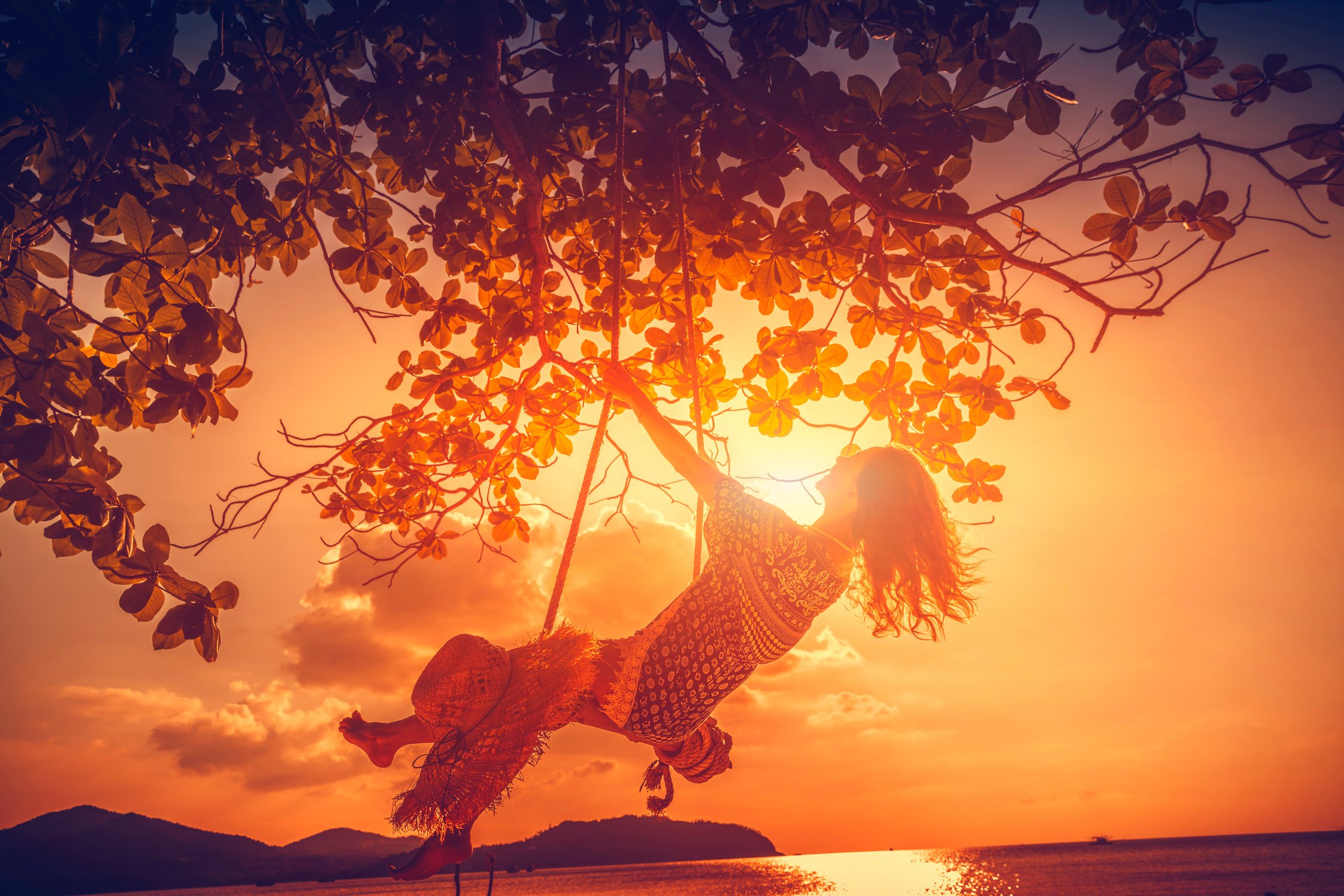 Woman at sunset swing